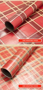 Detail of red Scottish plaid gift wrapping paper rolls showing texture and grid pattern
