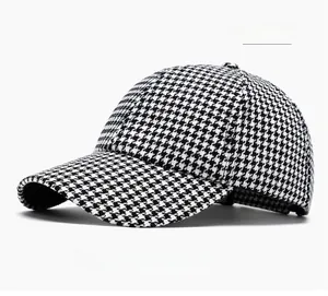 Detailed view of the black and white houndstooth pattern on a curved brim baseball cap