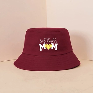 Close-up of wine red bucket hat with white Softball MOM text and heart softball logo