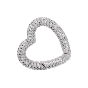 Macro detail of heart-shaped jewelry clasp with white zircons in silver-plated brass