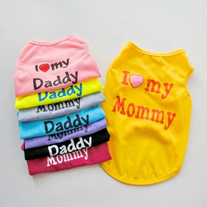 Flat lay of breathable pet tank tops in eight colors with Mommy and Daddy slogans