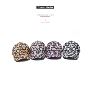 Detailed flat lay of four cotton floral baseball caps in various pastel color palettes