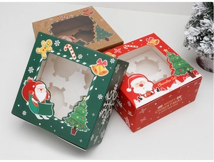 Detailed view of red and green Christmas cupcake boxes with clear windows and festive prints