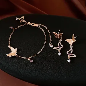 Luxurious gold butterfly jewelry set with purple gemstones including bracelet and earrings