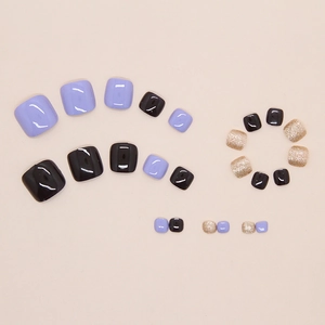 Faux ongles d'orteils en violet, noir et pailleté or avec finition brillante