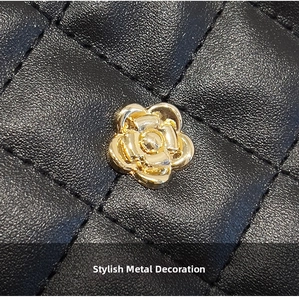 Detail of black quilted leather texture and gold-tone camellia metal hardware decoration