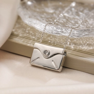 Minimalist silver envelope pendant necklace with sparkling zircon on a satin base