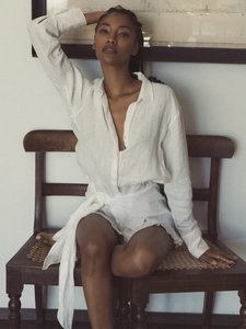 Detail of white linen shirt dress with lapel collar and waist tie detail