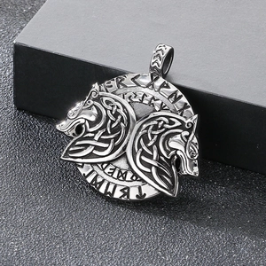 Close-up of Viking Celtic knot pendant with dragon heads and runic wheel engraving