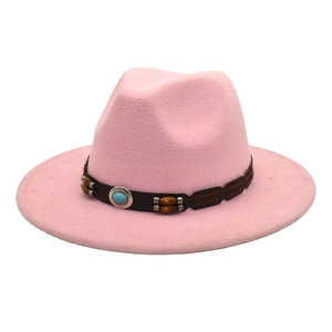 Detail of pink fedora hat with brown leather band featuring turquoise and wooden beads