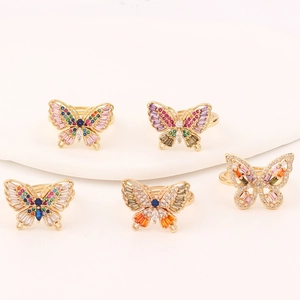 Close-up of five colorful butterfly rings with vibrant cubic zirconia and gold plating