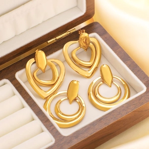 Golden vintage heart and circle drop earrings in a luxury velvet wooden jewelry box