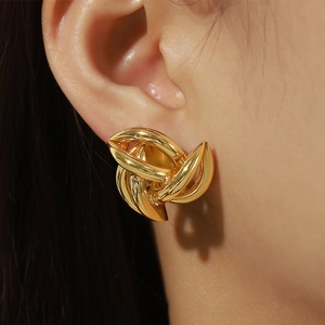 Unique minimalist gold twist knot earrings with multi-layered spiral design in copper