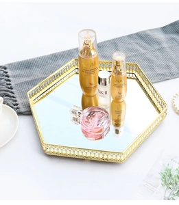 Detail of a golden hexagonal mirrored tray for cosmetic storage and home decor