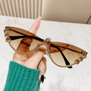 Modern rimless cat eye sunglasses with gradient brown lenses and gold rhinestone detailing