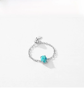 Close-up of S925 sterling silver chain ring with oval blue opal and adjustable ball