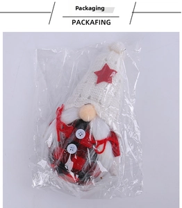 Christmas gnome doll detail in packaging featuring a red star on a white knitted hat