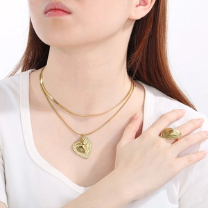 Elegant 18K gold stainless steel jewelry set with heart texture necklace and ring on model