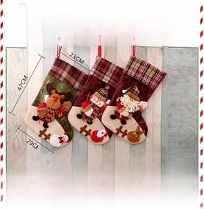 Detail view showing large plaid Christmas stockings with 3D applique deer and snowman
