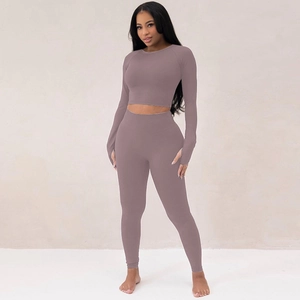 Detail of mauve ribbed yoga set featuring thumb holes on sleeves and high waist yoga pants