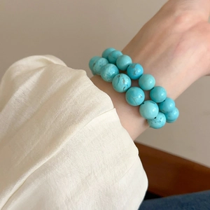 Detail of double-layered turquoise beaded bracelet with natural brown mineral patterns