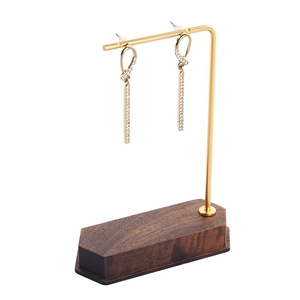 Walnut and gold metal earring display stand featuring long tassel earrings with zircons