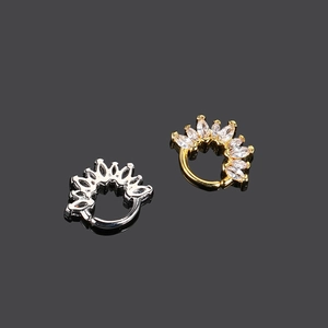 Detailed macro view of gold and silver nose rings featuring marquise-cut cubic zirconia