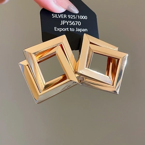 Detailed shot of double square nested gold earrings featuring 925 silver texture