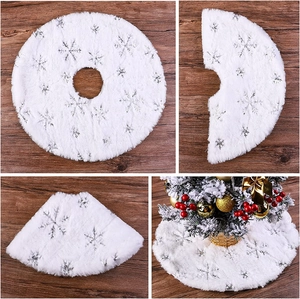Detail of white plush Christmas tree skirt with silver snowflake sequins and soft faux fur