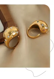 Detail of adjustable gold-plated drop ring with sparkling colorful zircon inlay