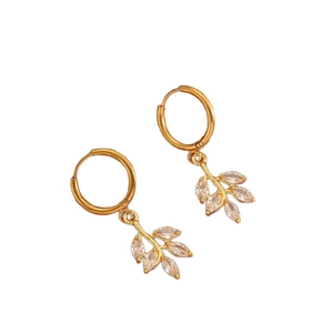 Golden stainless steel leaf pendant earrings with sparkling cubic zirconia on white background