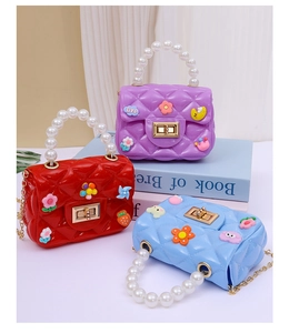 Close-up of mini jelly bags with pearl handles and cute cartoon floral decorations