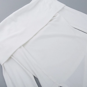 Close-up of white off-shoulder ribbed knit top showing fabric texture and shoulder detail