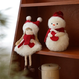 Plush red and white snowman and girl dolls as festive Christmas tree hanging ornaments