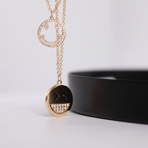 Detail of double-layer gold smile necklace with micro-pave diamond-set round pendants