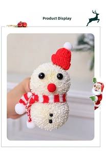Detailed close-up of a handmade snowman flower ornament with red knitted hat and scarf