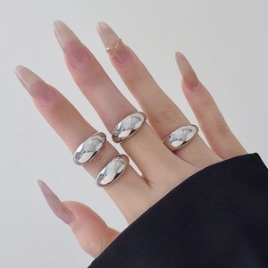Polished silver titanium steel rings shown on hand with minimalist aesthetic