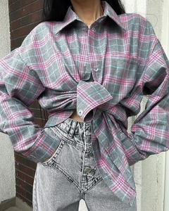 Detail of pink and gray plaid shirt fabric texture and waist tie styling with jeans