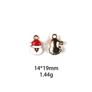 Detailed view of red and white enamel Santa Claus charm measuring 14x19mm with gold base