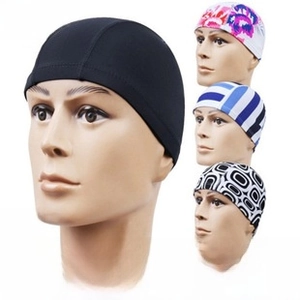 Collage of elastic swim caps in solid black, striped, and patterned quick-dry fabrics