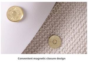 Detail of a white woven bag featuring a gold magnetic snap button closure and texture