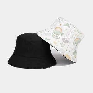 Double-sided bucket hat with solid black and ocean pattern including jellyfish and starfish