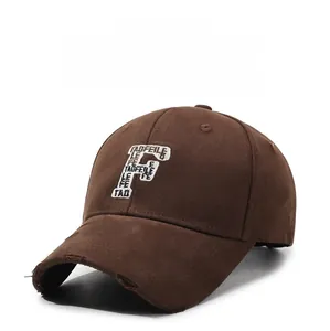 Close-up of distressed brim details and premium letter F embroidery on a brown cotton baseball cap