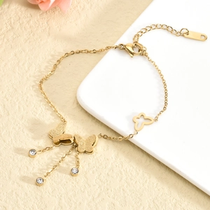 Elegant gold butterfly bracelet with frosted texture, tassels and sparkling rhinestones