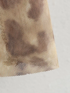 Close-up of leopard print mesh fabric showing detailed breathable net texture