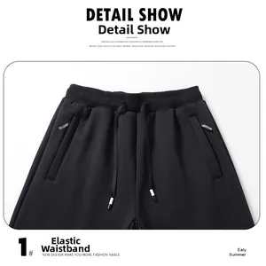 Detail of black jogger pants featuring an elastic waistband and drawstring closure