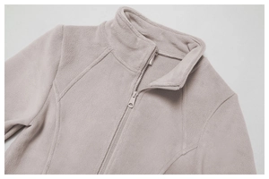Close-up of warm grey fleece texture and sturdy full zipper on standing collar jacket