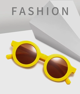Detail of yellow round frame kids sunglasses with dark lenses and UV400 protection