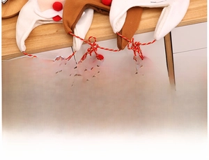 Detail of handmade Christmas plush accessory with soft fleece and festive red pompom