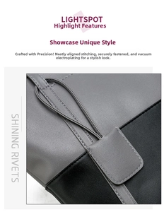 Close-up of gray and black patchwork bag showing precise stitching and matte leather texture